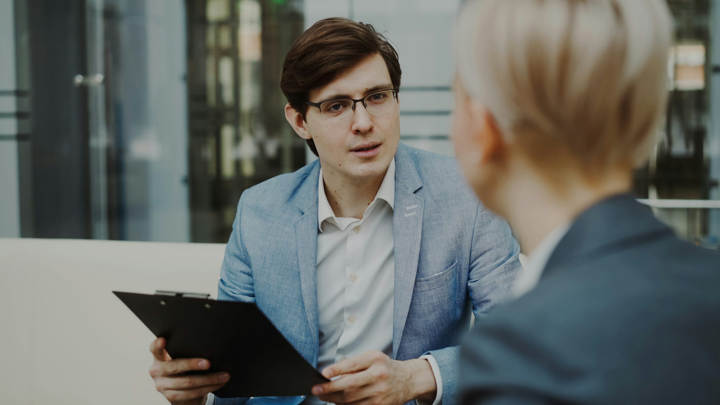Recruiter interviewing a candidate in a modern office