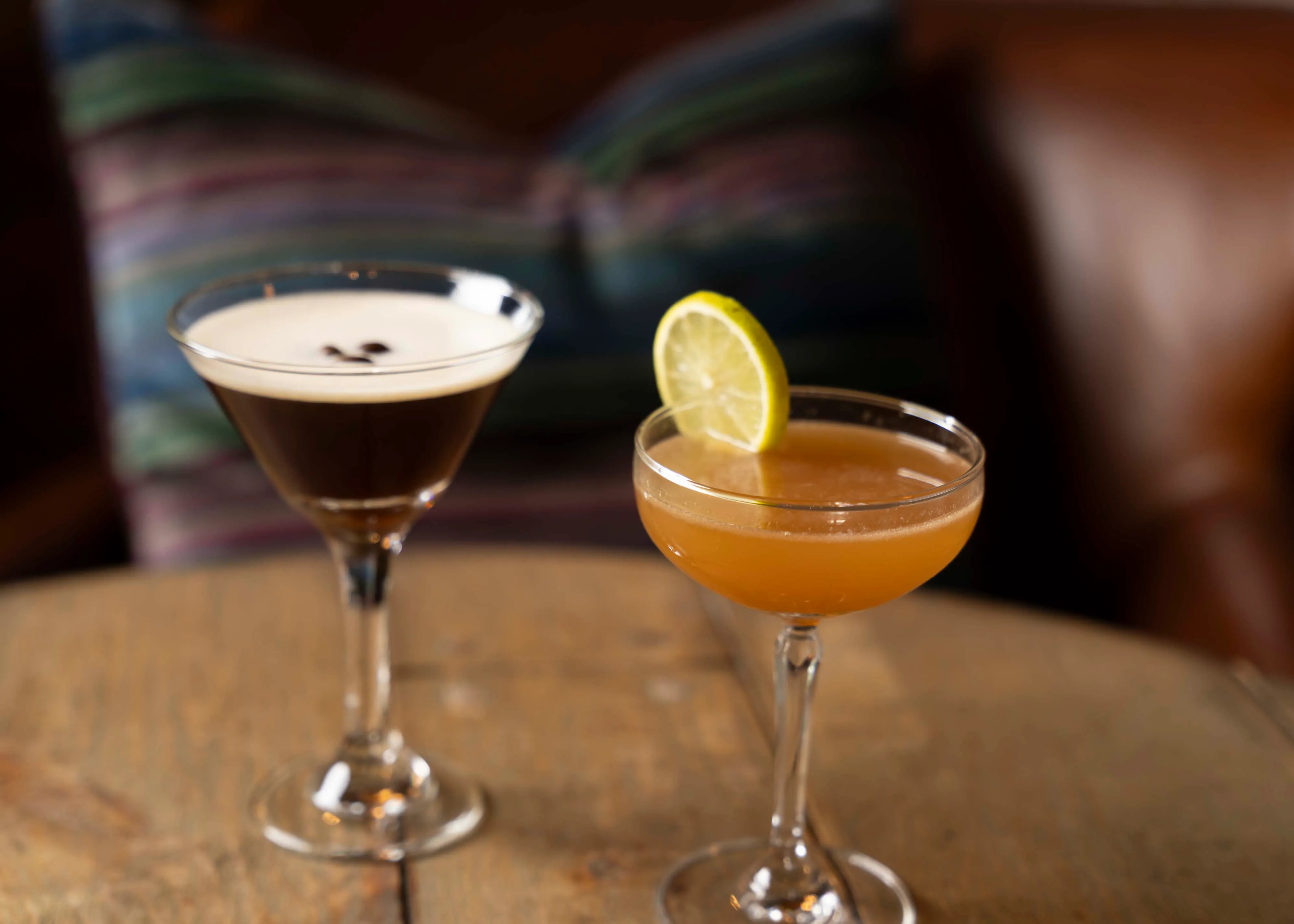 Two cocktails made at Crawford's in downtown Sioux Falls sitting on a wood table.