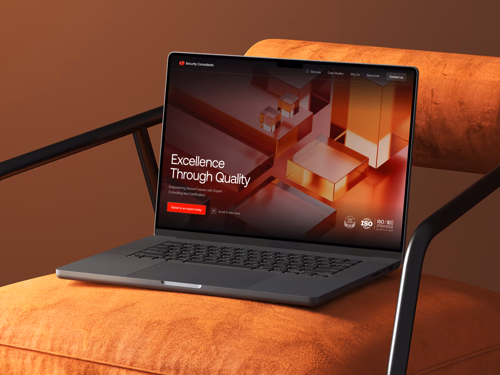 Laptop displaying a website for security consultants with the slogan 'Excellence Through Quality' on an orange fabric chair.