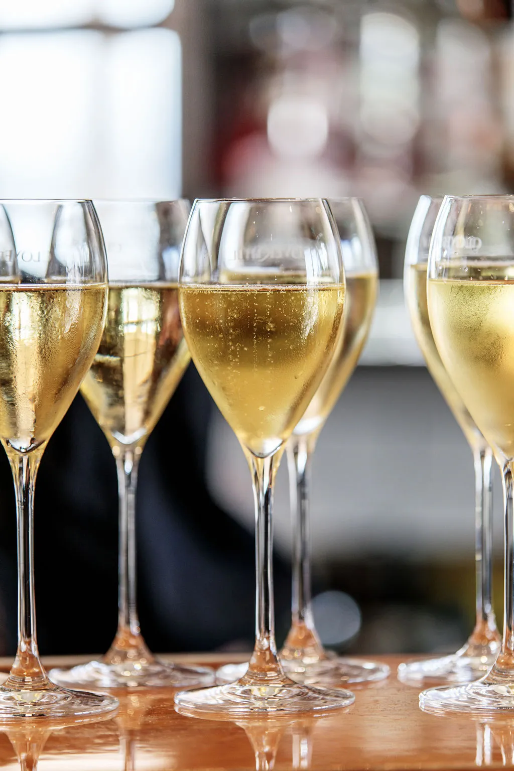 A suite of bubbling champagne glasses, zoomed in to see the lovely golden colour and effervescence.
