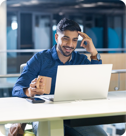 Support agent smiling while working on a laptop