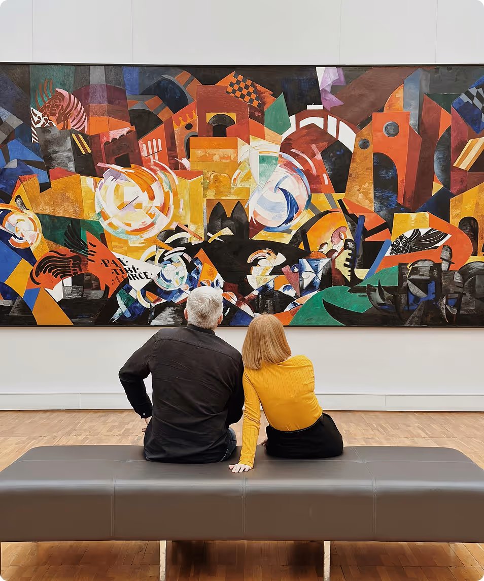 Two people sitting on a bench in an art gallery, viewing a large colorful abstract painting on the wall.