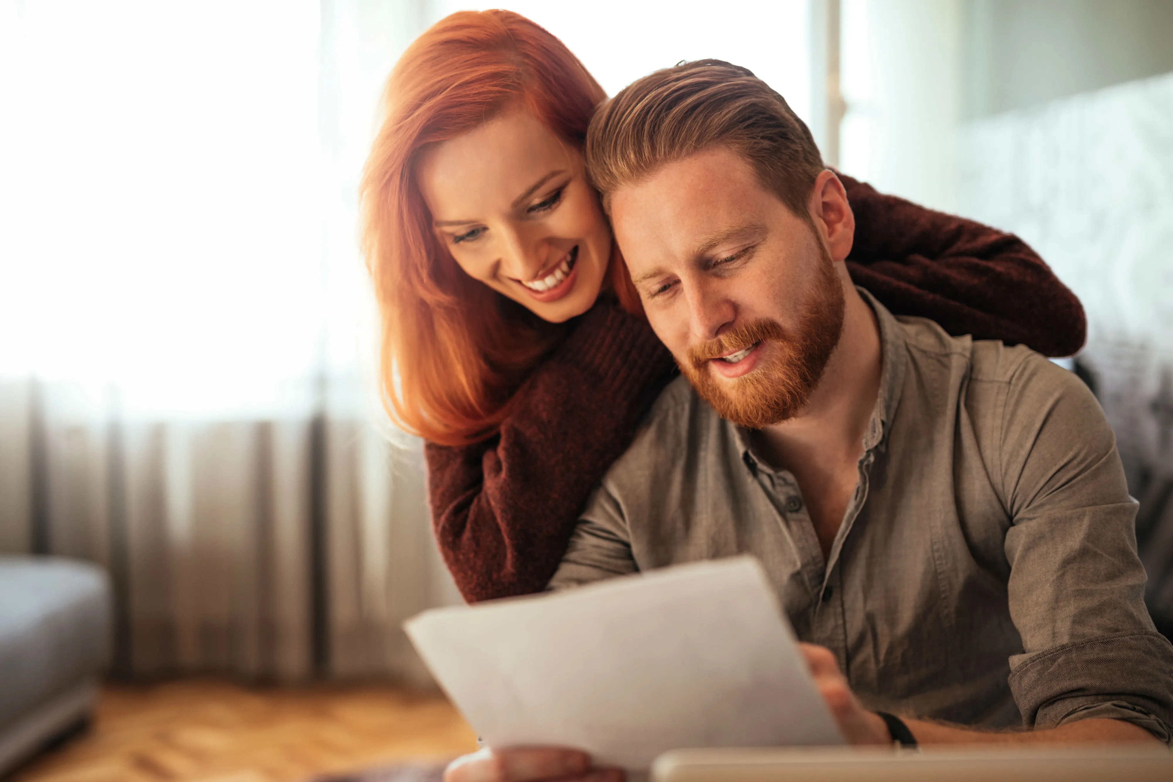 A husband and wife working from their home office.