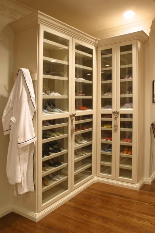 A shoe closet with slanted shoe racks.