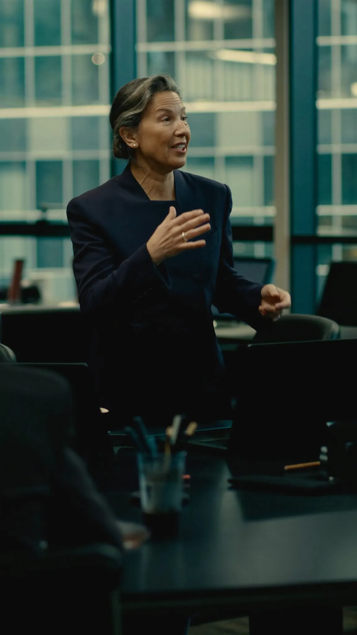 Senior executive presenting confidently to her team in a boardroom