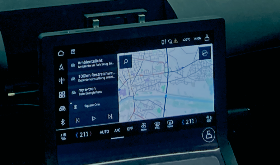 A close-up view of a car dashboard featuring a modern digital display with indicators and controls.