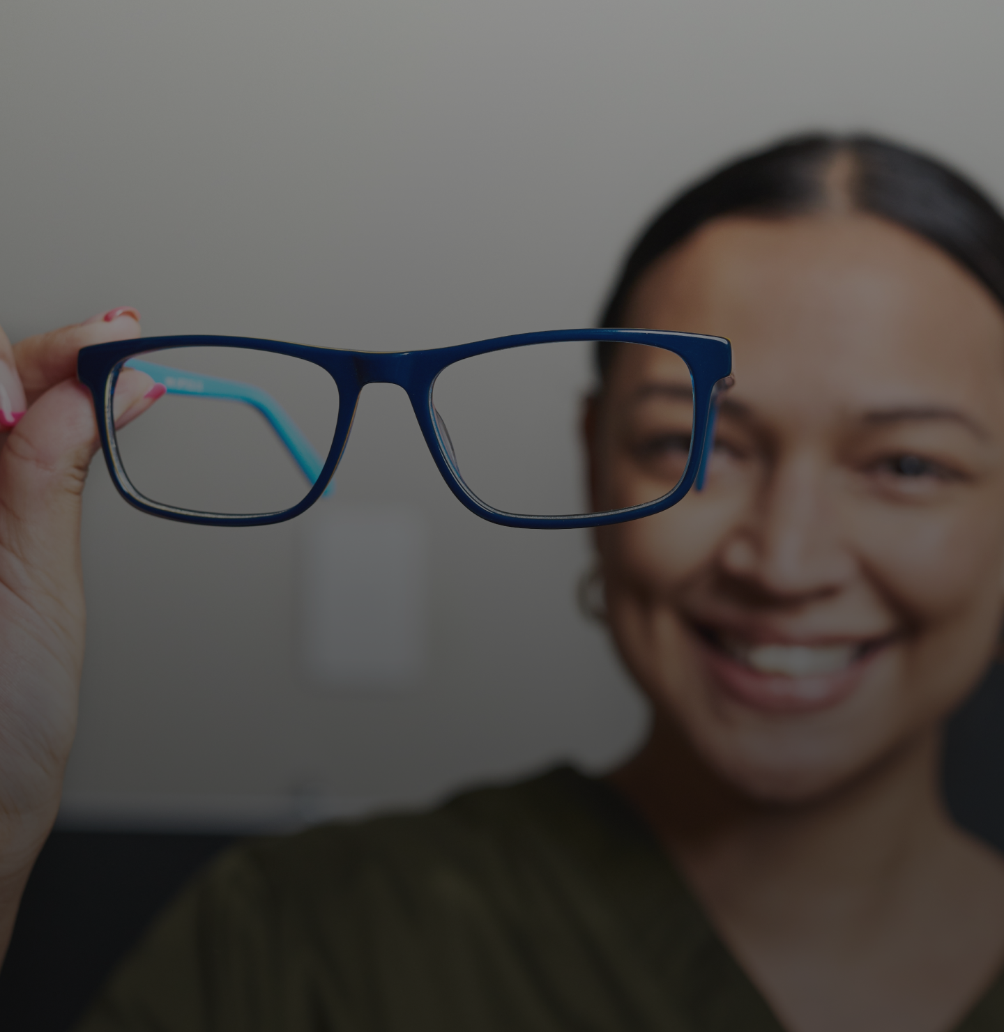 A car navigates a snowy road at night, illuminated by headlights against the dark, wintry landscape.