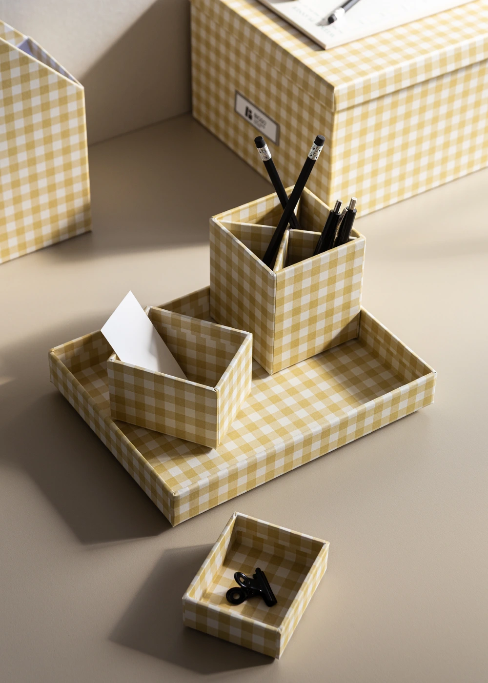 Bigso yellow checkered desk organizer set with compartments for pencils, pens, notes, and small accessories. Stylish Scandinavian design made from recycled fiberboard and paper, perfect for sustainable office and home organization.