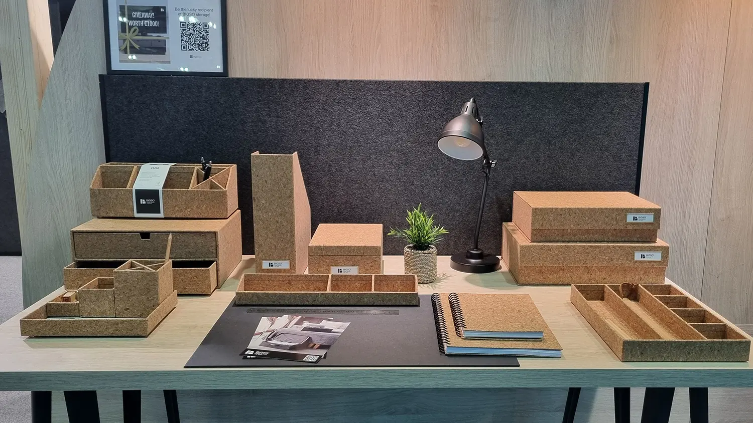 Bigso Cork Collection desk organizers and storage boxes displayed in a modern workspace setup. Includes cork magazine files, storage drawers, document trays, and notebooks, designed with eco-friendly cork and recycled materials for sustainable office organization.