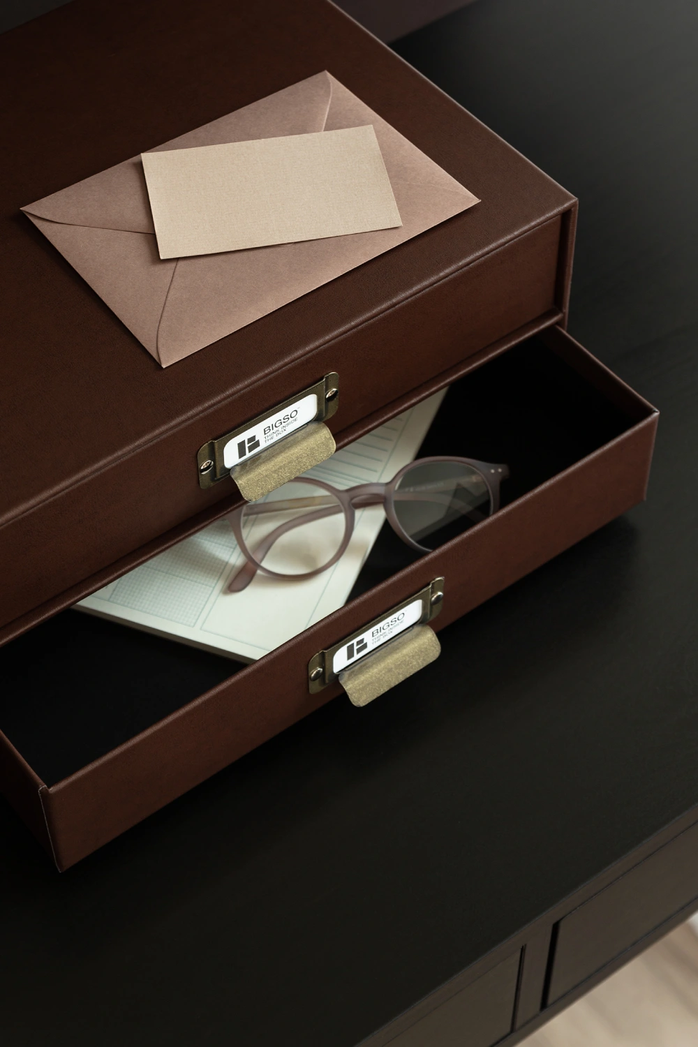 Bigso recycled leather document storage box with drawers in brown, featuring brass label holders, ideal for organizing letters, notebooks, and office essentials.