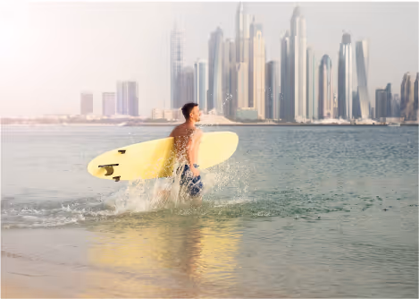A Man Holds a Paddle Board in Dubai