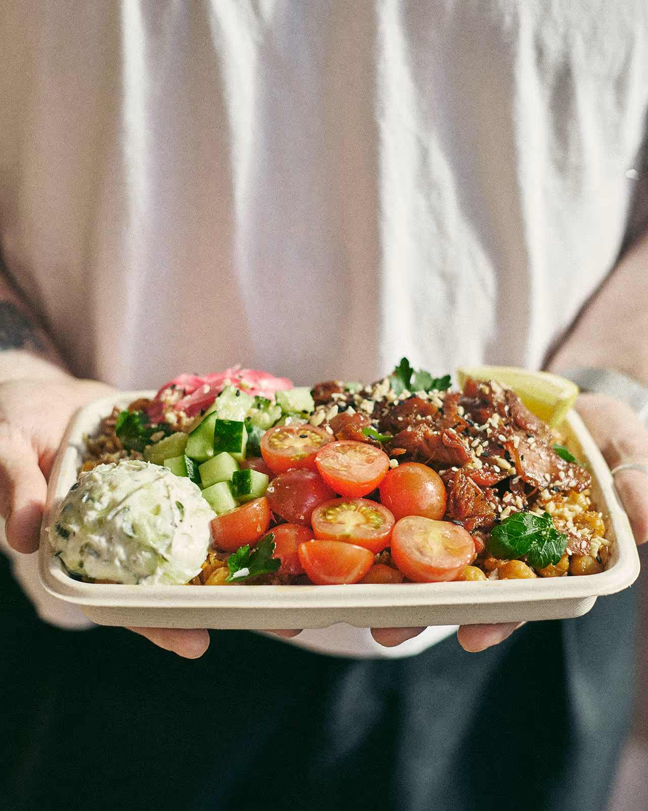 urban greens staff member holding salad