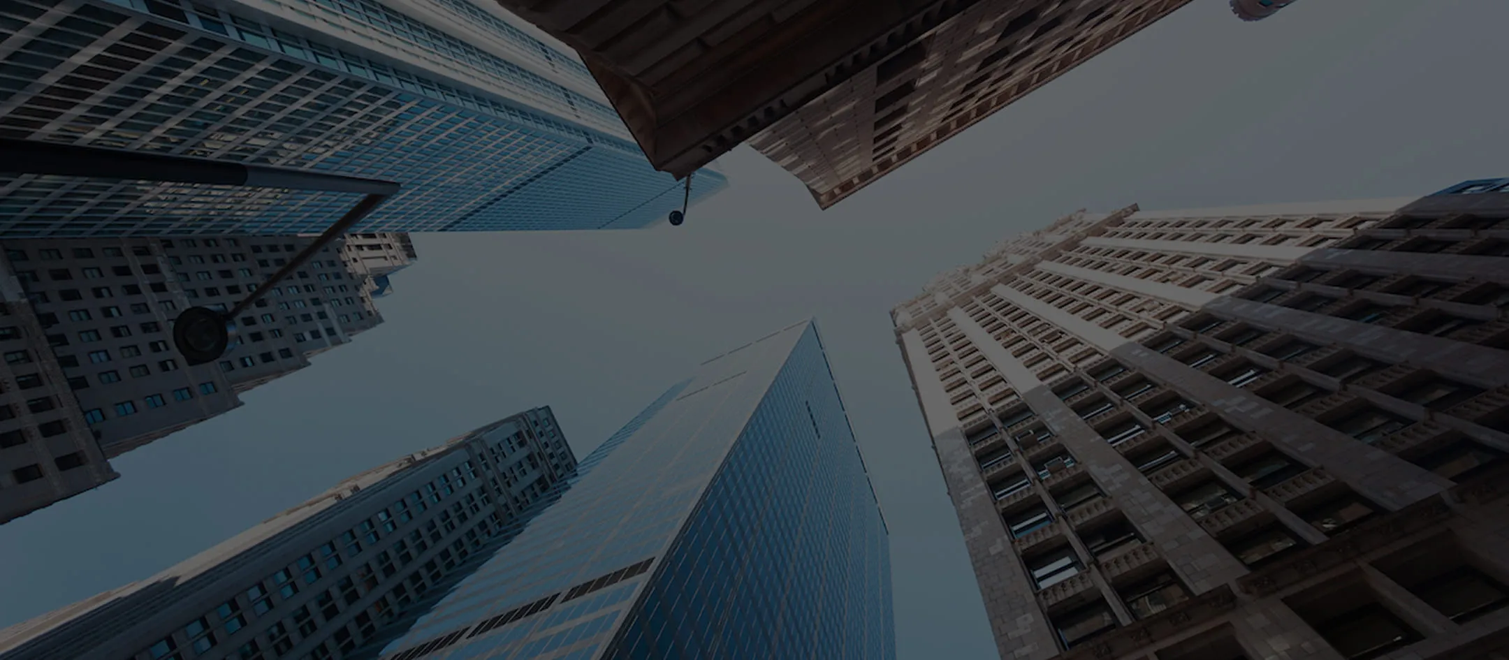 Looking up at tall buildings in a city.