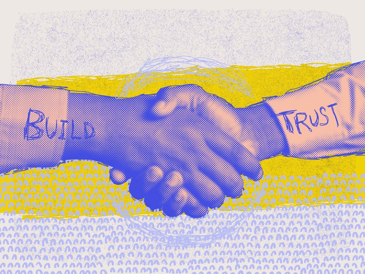 two hands shaking, with the words build trust written over them 