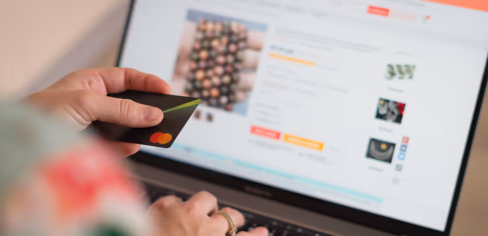 Person holding their credit card and online shopping