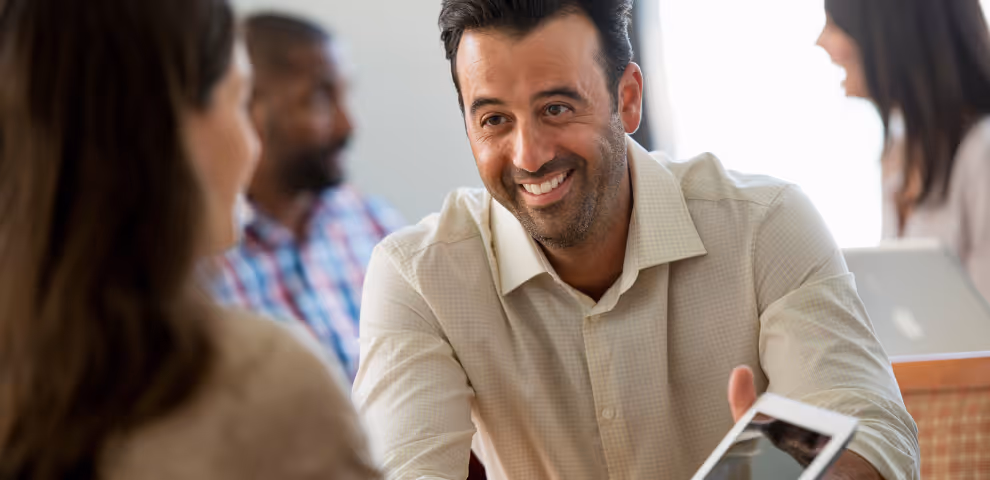 Man sitting across the table from a woman smiling