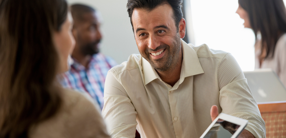 Man sitting across the table from a woman smiling