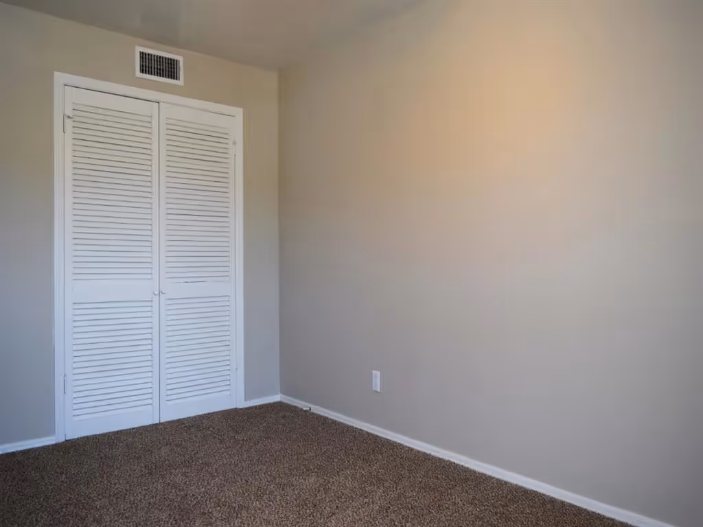 Empty bedroom with closed closet door