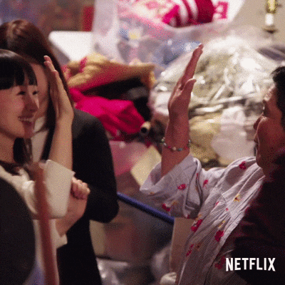 GIF of two people giving each other a high five