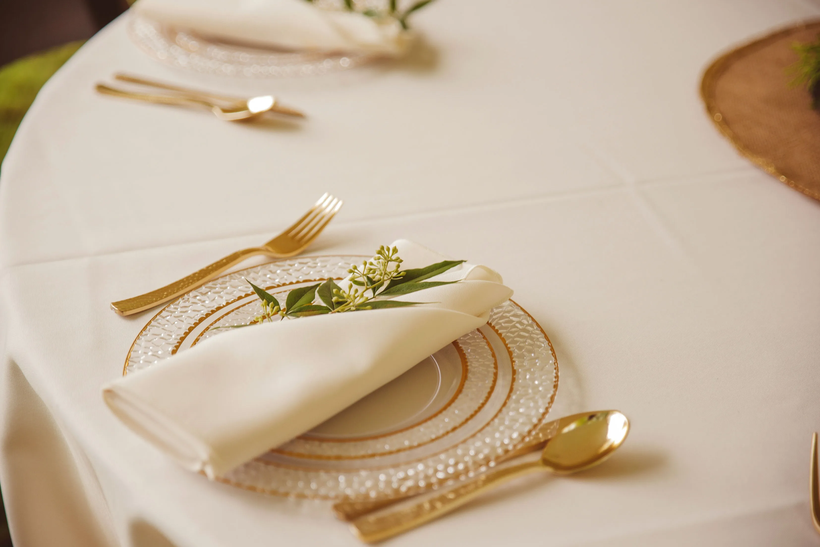 A table with plates, cutlery, and napkins