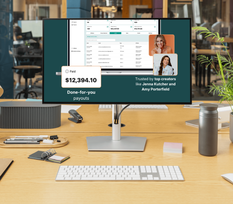 Modern office desk with a computer monitor displaying a dashboard showing $12,394.10 paid and endorsements from creators Jenna Kutcher and Amy Porterfield.