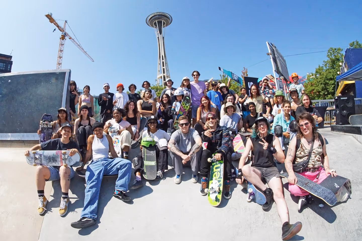 skate like a girl group posing in front of the space needle