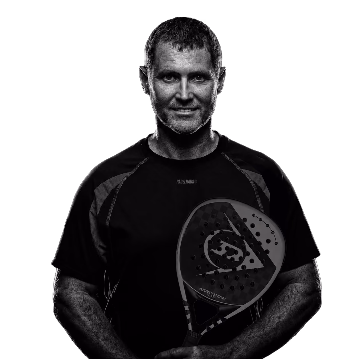 Smiling man in a black shirt holding a padel racket upright in front of him.
