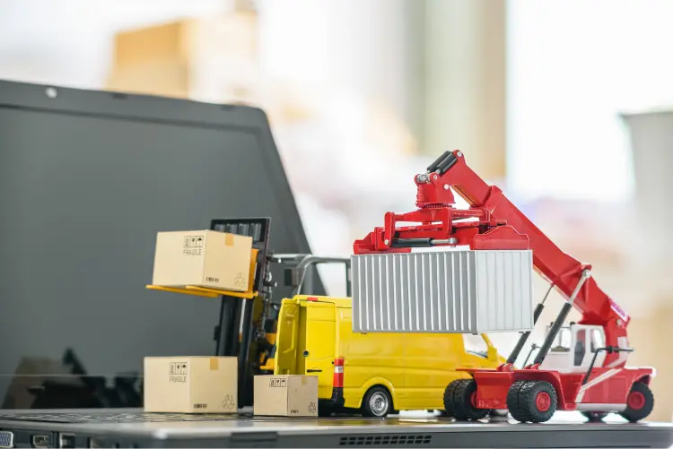 Small truck loads boxes near a computer