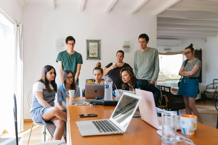 Group of people looking on macbook