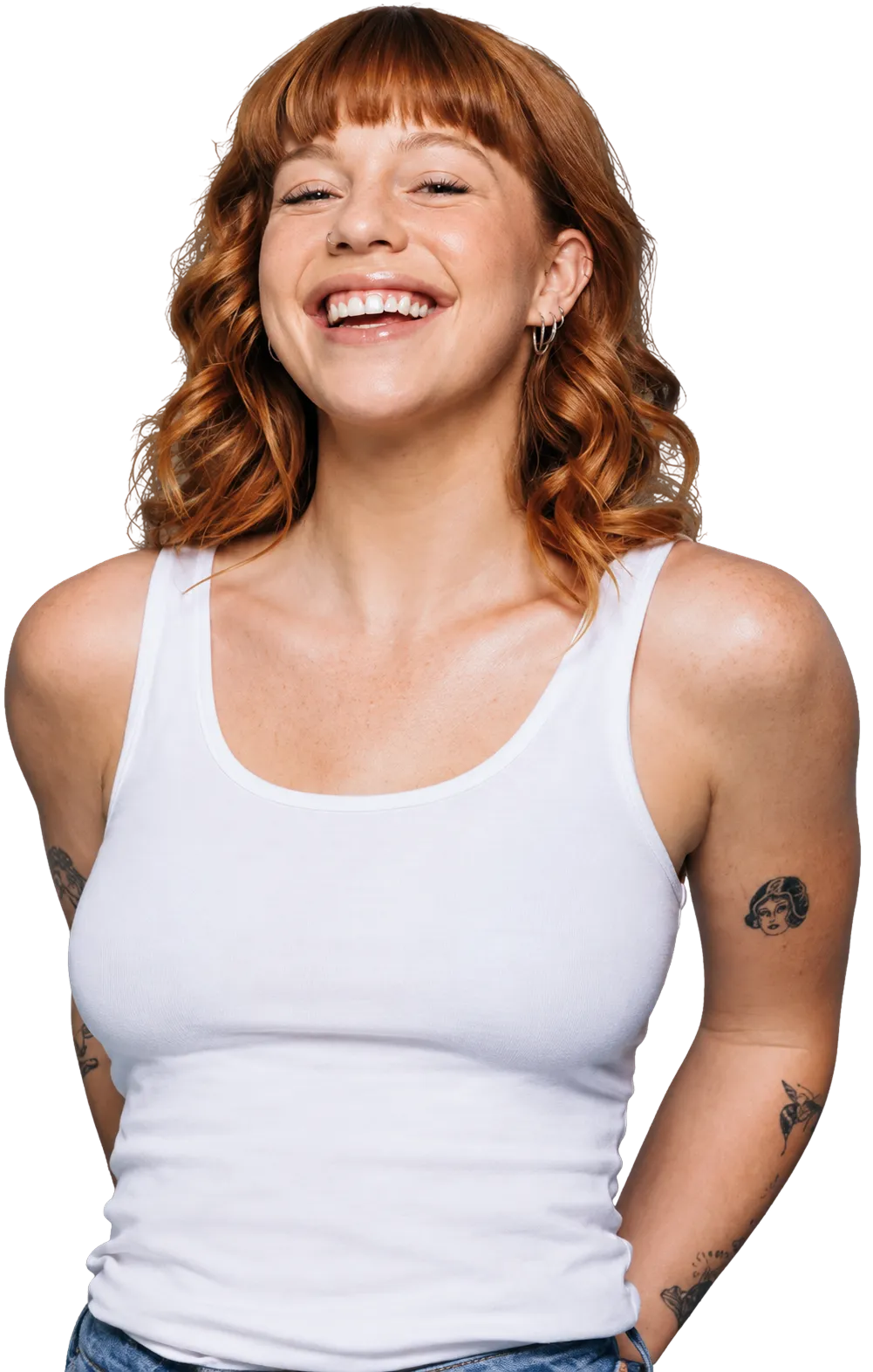 a woman smiling with tattoos on her arm