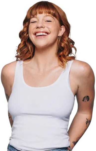 a woman smiling with tattoos on her arm