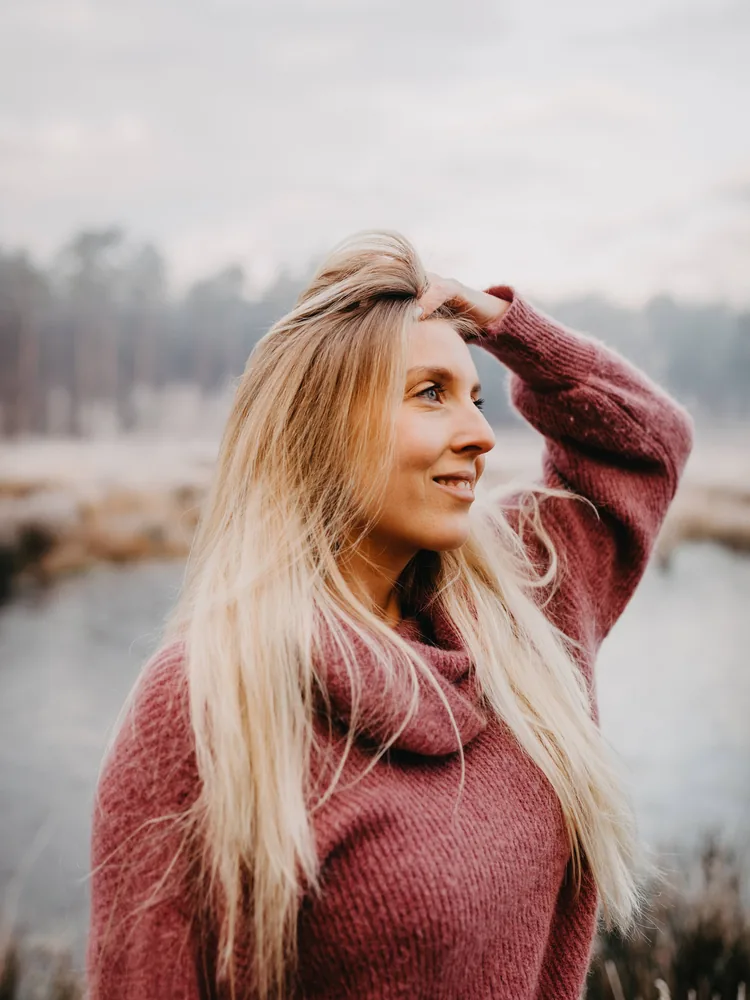 Shannen Rasking in de wind bij een ven, hand in haar haar