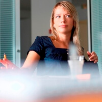 woman listens during office meeting