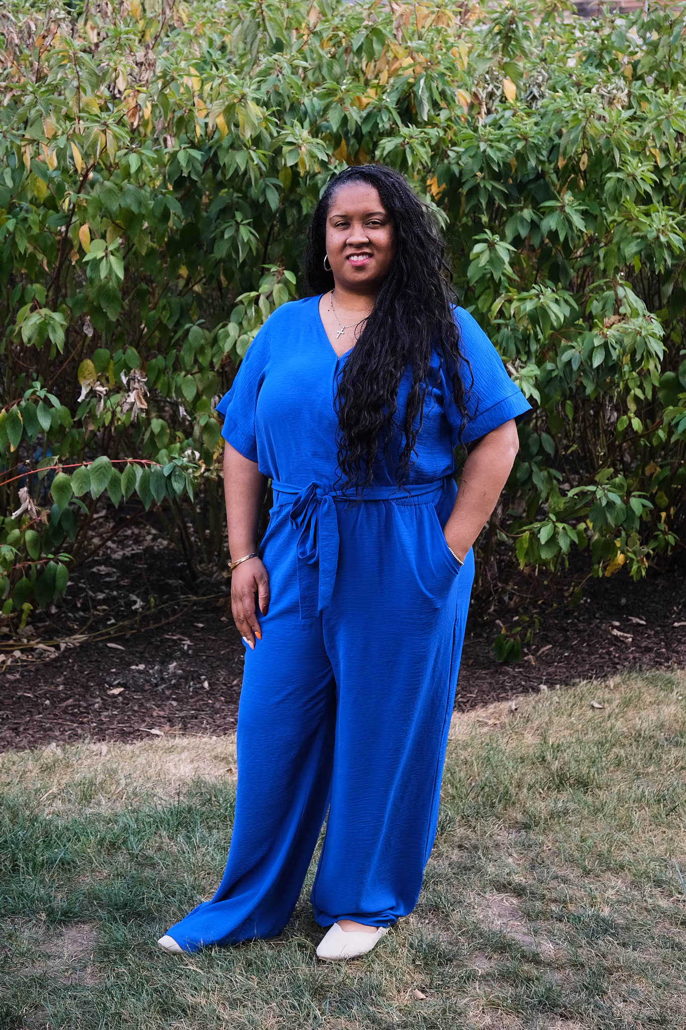Keva Pitts-Giraud smiling outdoors in a blue jumpsuit