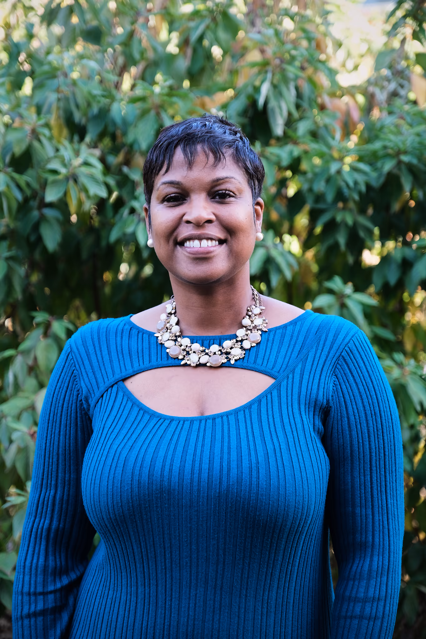 Cindy Casseus smiling in a blue sweater outdoors