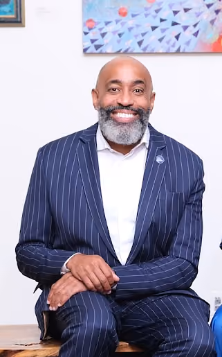 Superintendent of District 23 smiling in a navy pinstripe suit