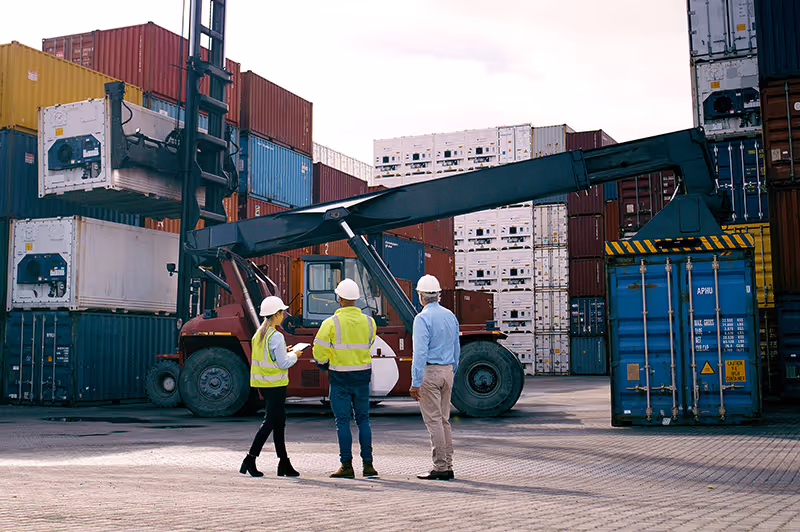 Workers at a container shipping yard