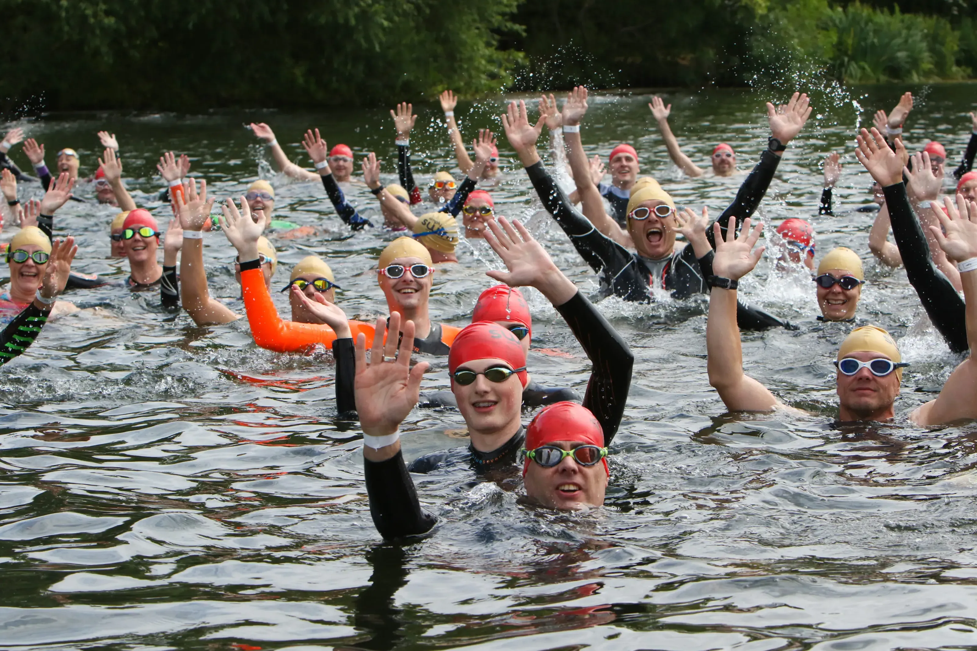 Three swimmers smiling at start of a Chillswim event
