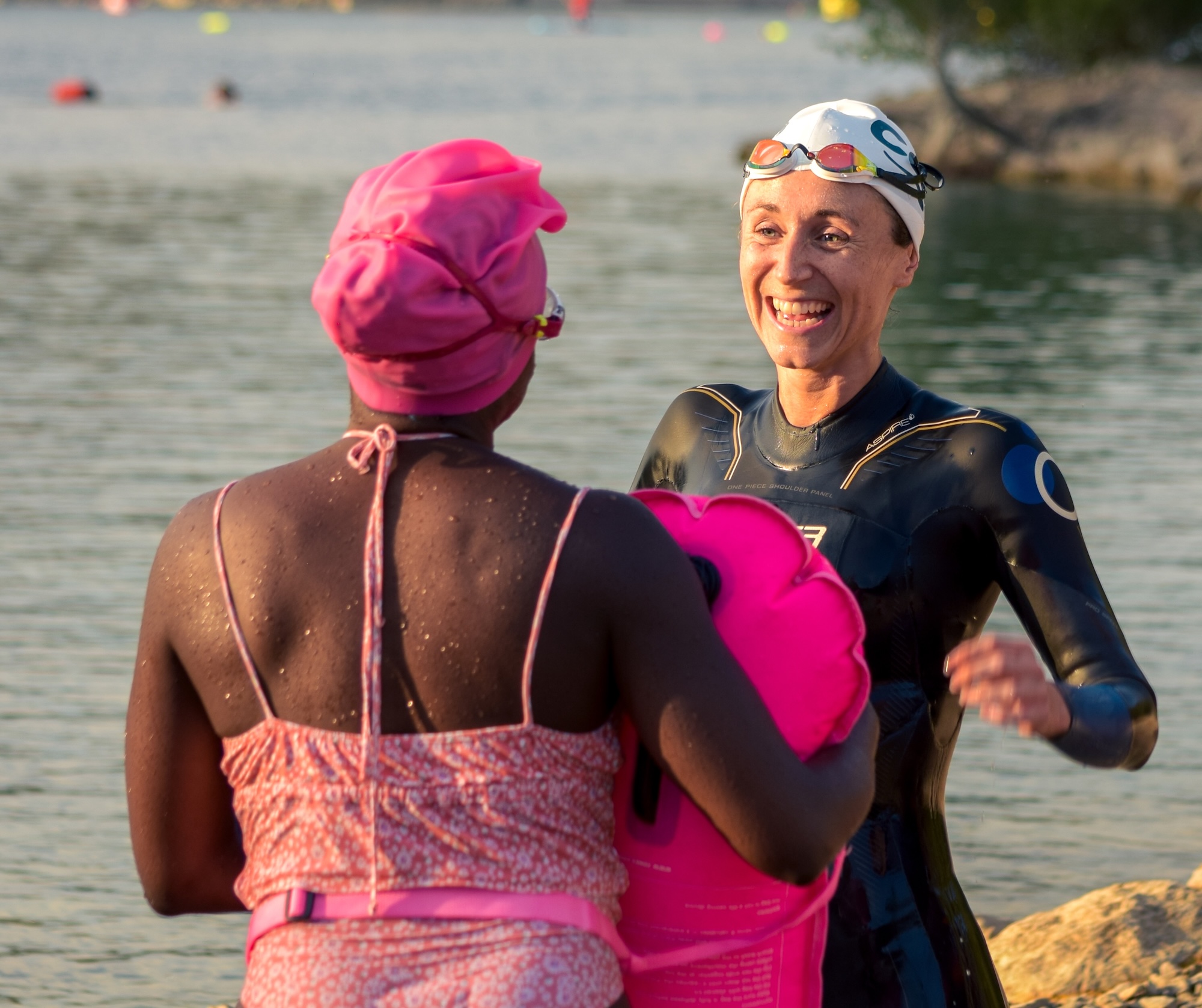 Three swimmers smiling at start of a Chillswim event