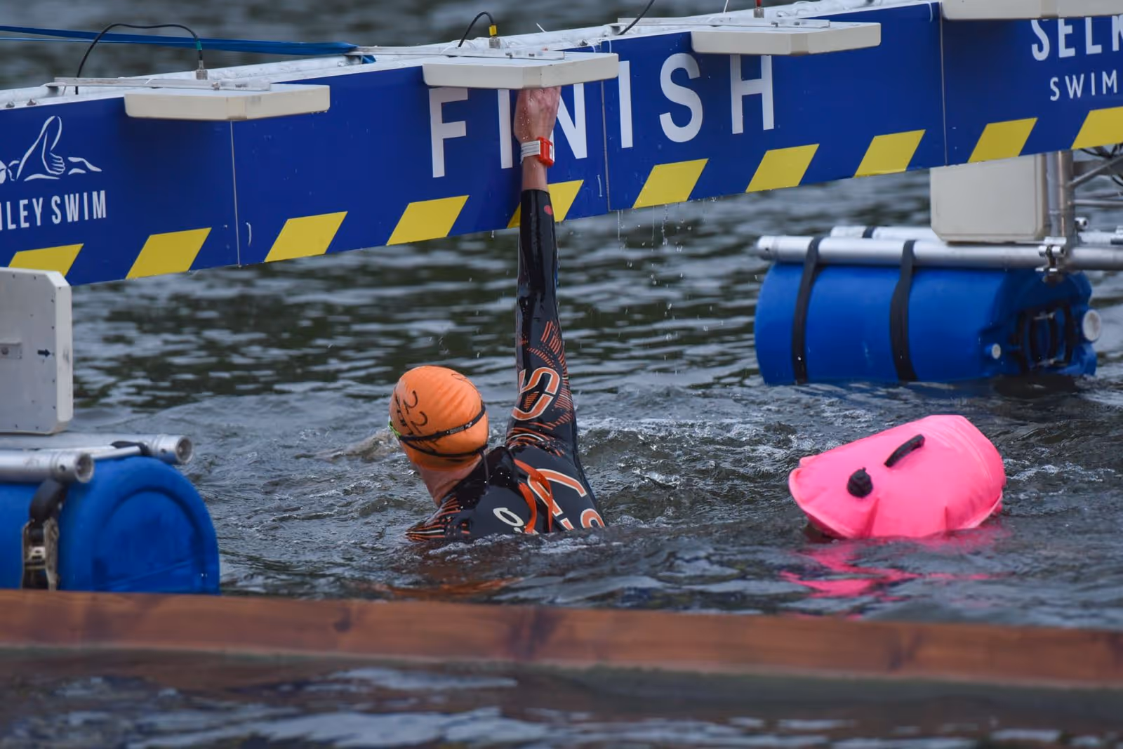 Three swimmers smiling at start of a Chillswim event