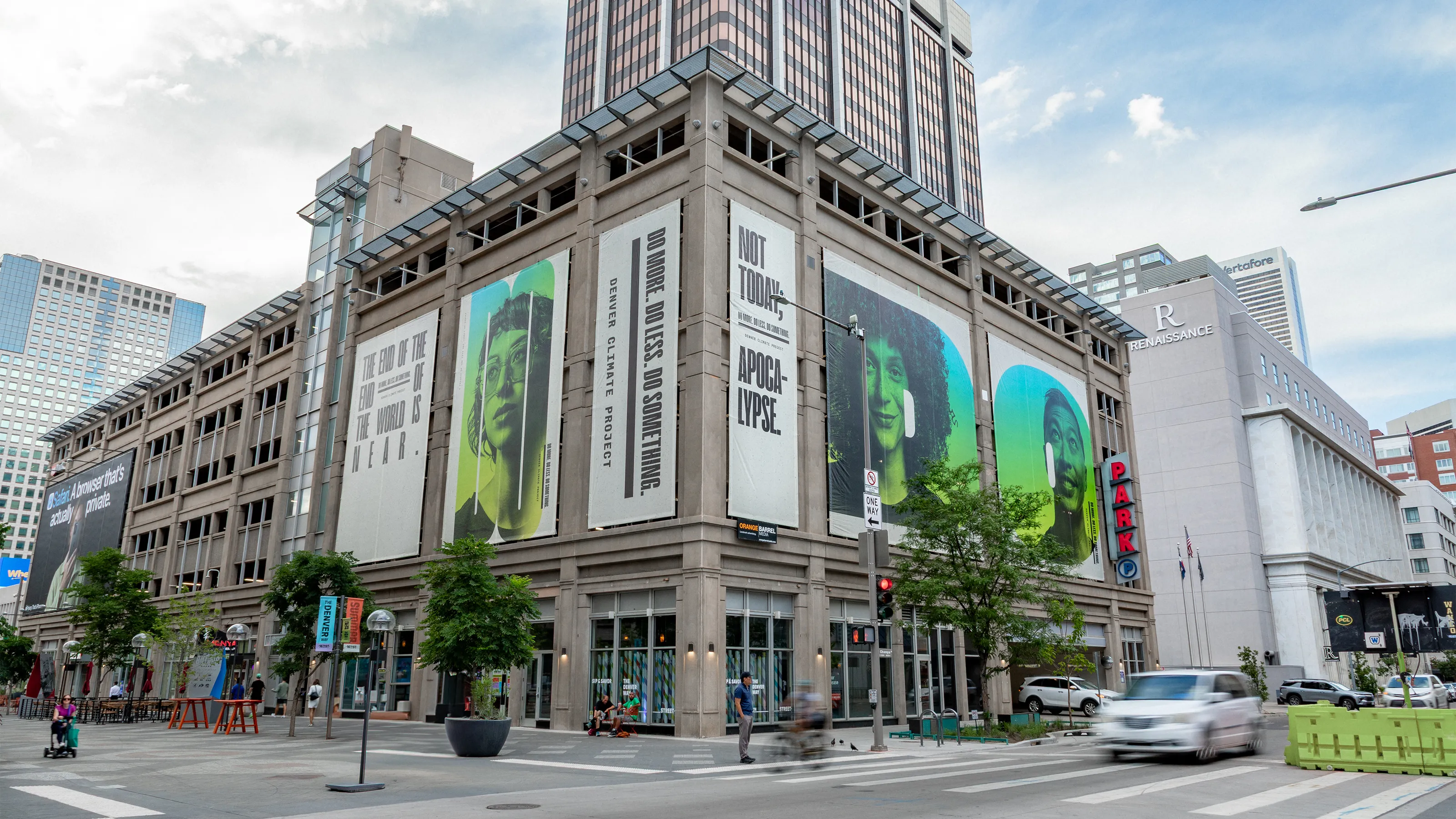 A corner of a large city building with 6 different large posters