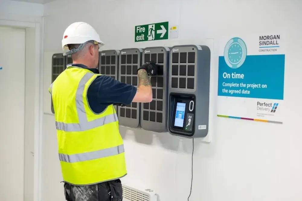 A Morgan Sindall employee picking up a pair of keys from a Keycafe SmartBox.