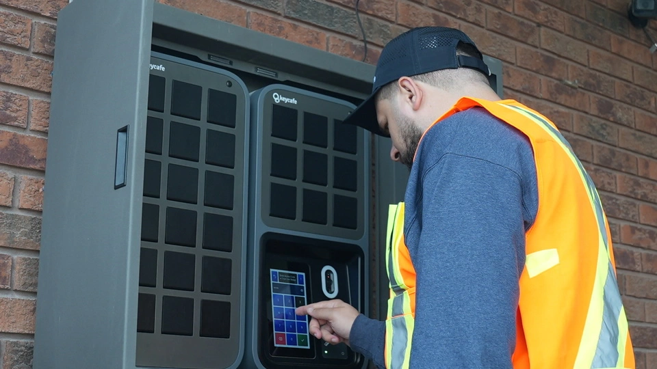Man in high-vis vest using an outdoor Keycafe SmartBox
