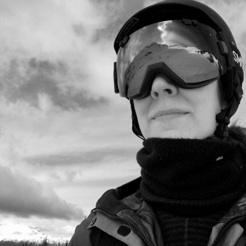 Tana Green in ski goggles and winter gear, photographed in black and white