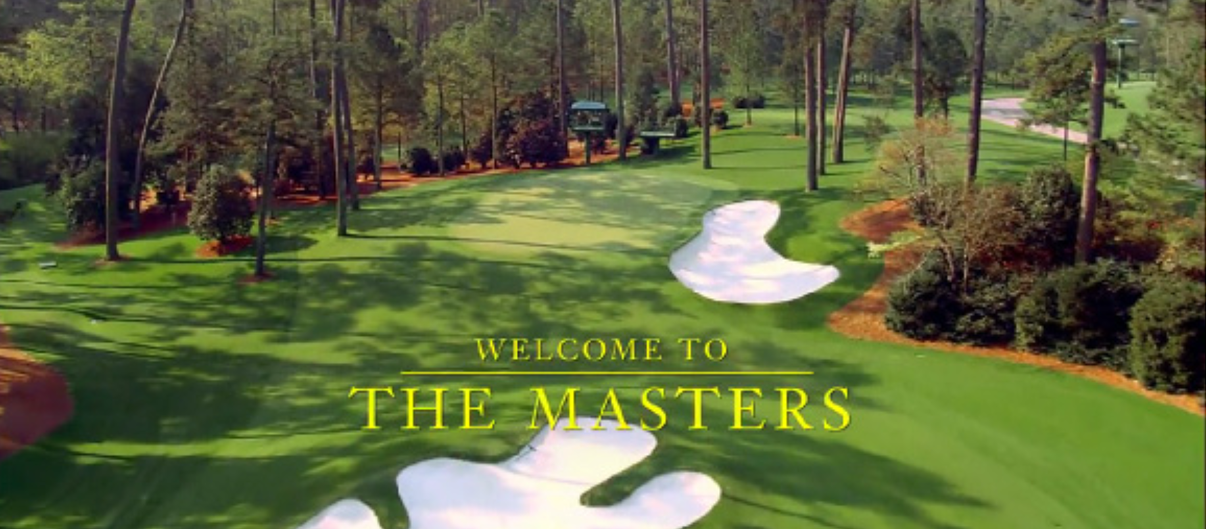 Aerial view of Augusta National Golf Club's manicured fairways and azalea-bordered greens, overlaid with the gold-on-green wordmark "Welcome to The Masters."