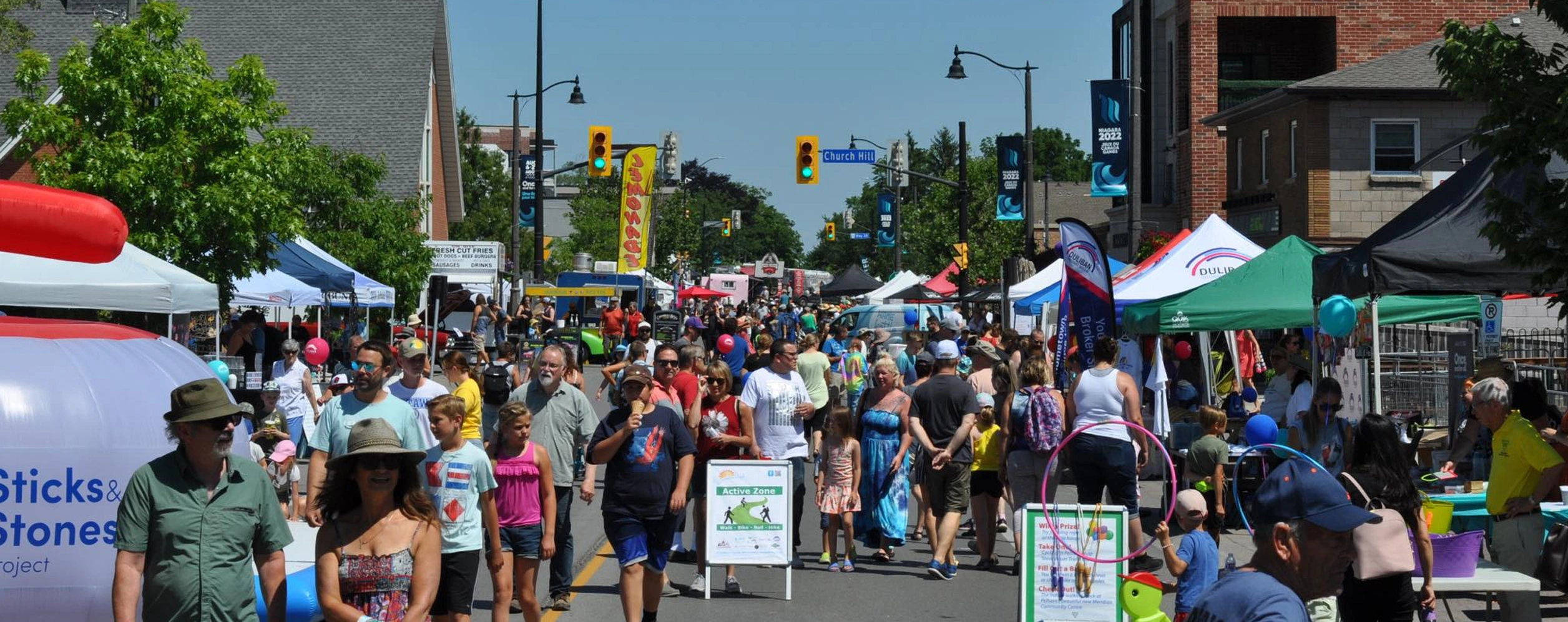 Downtown Pelham Summerfest with patrons lining the streets surrounded by vendors