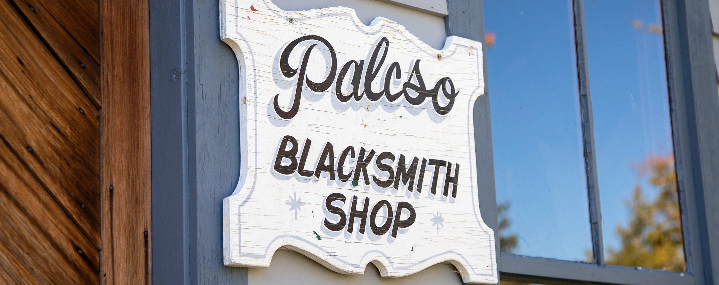 Closeup of historic white sign reading "Palcso Blacksmith Shop" representing Marshville Heritage Festival