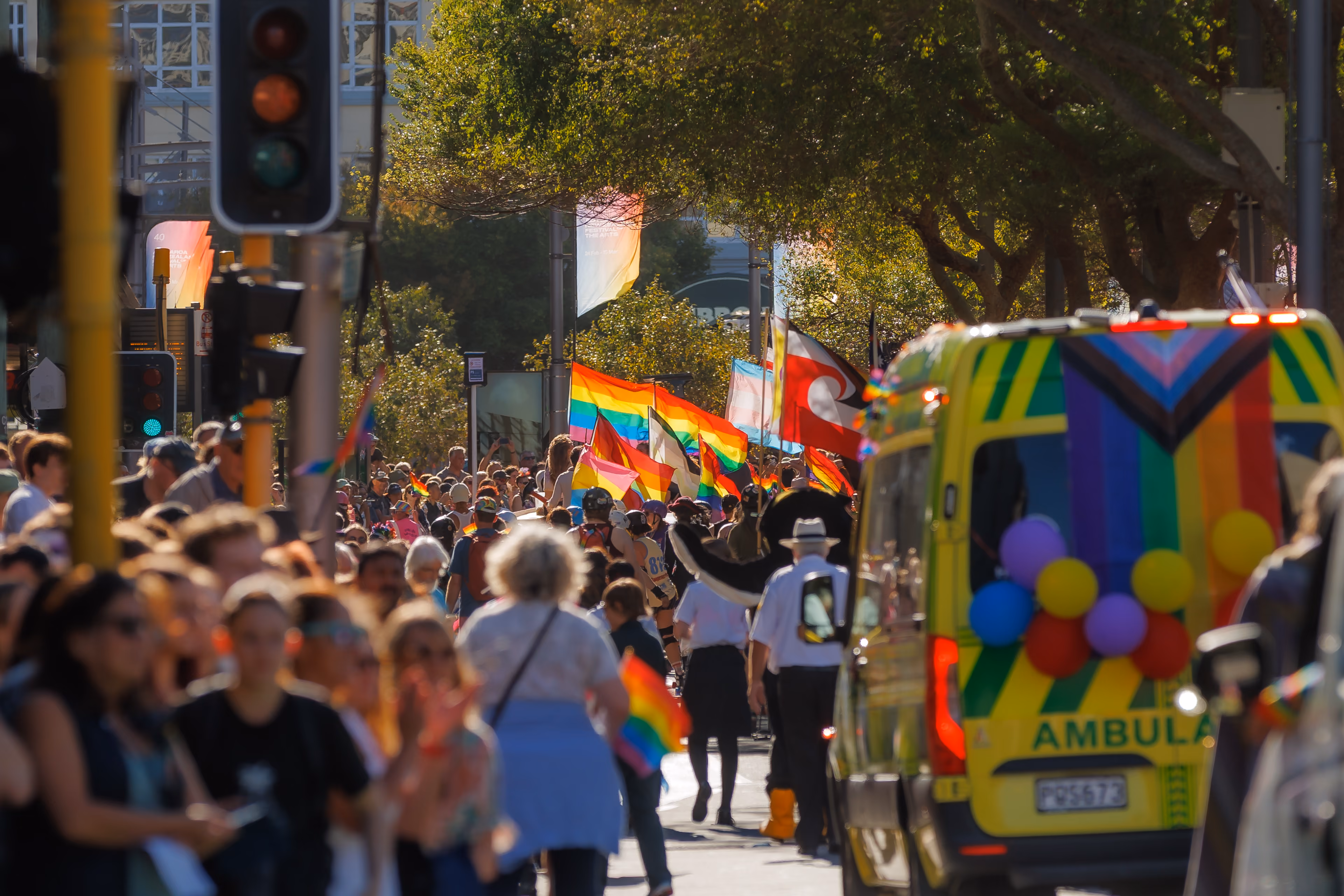 Crowds and rainbow flags filling Courtenay Place during the Wellington Pride Parade