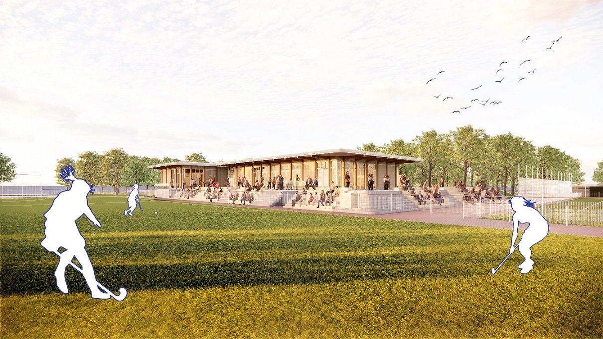 Het nieuwe sportcomplex Ringpass Delft ingebed in een groene omgeving met biodiverse beplanting en zicht op de hockeyvelden.