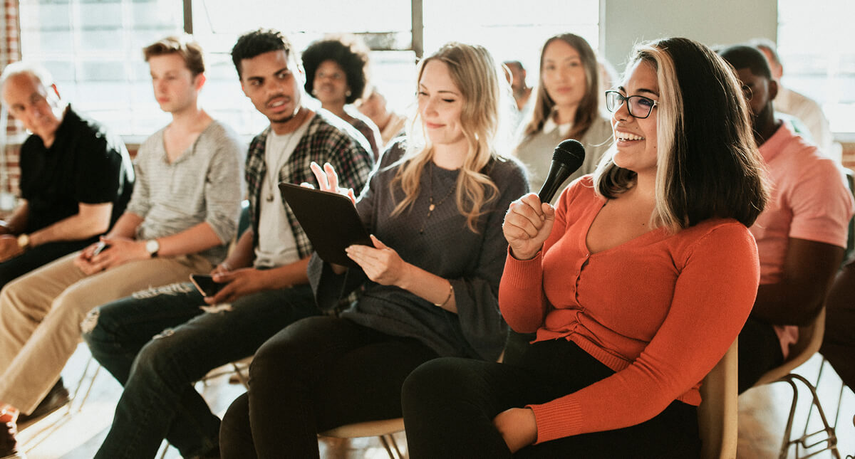 A group of people sitting at a meeting
